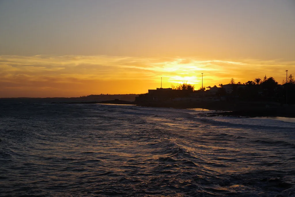 Sun setting over the ocean in gold light