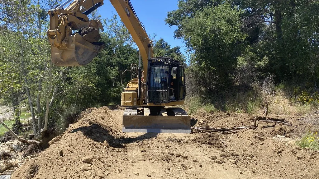 Compact excavator moving dirt on a sitework job